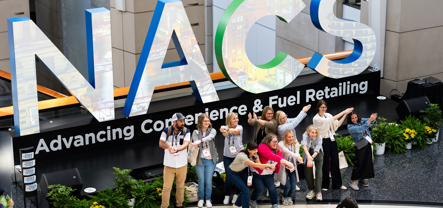people-taking-pics-in-front-of-NACS-sign